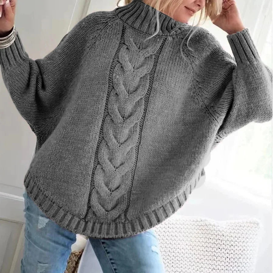 Women's cable-knit wool sweater with a mock neck